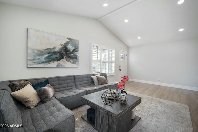 living room with vaulted ceiling and wood-type flooring