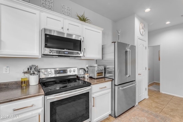 kitchen with appliances with stainless steel finishes and white cabinets