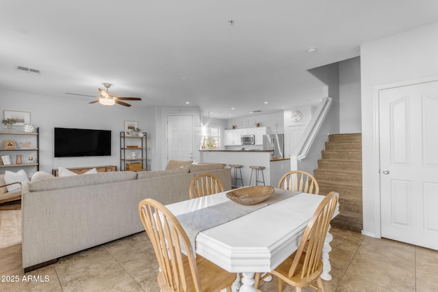 dining room with light tile patterned flooring and ceiling fan