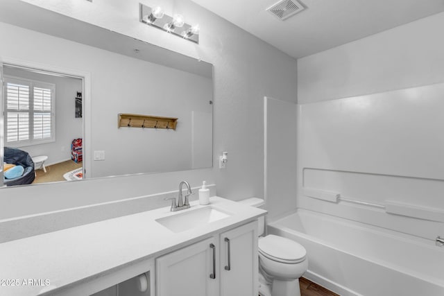 full bathroom with vanity, toilet, shower / washtub combination, and wood-type flooring