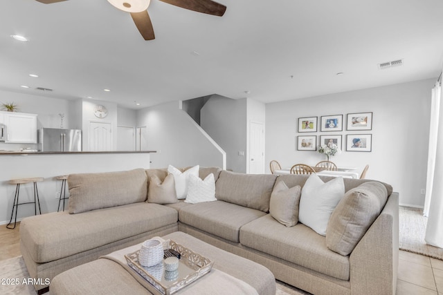 tiled living room with ceiling fan