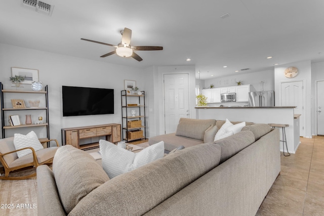 living room featuring ceiling fan and light tile patterned floors