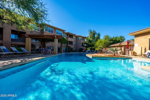 pool featuring a patio area and fence