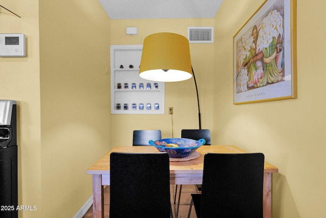 dining room featuring visible vents and baseboards