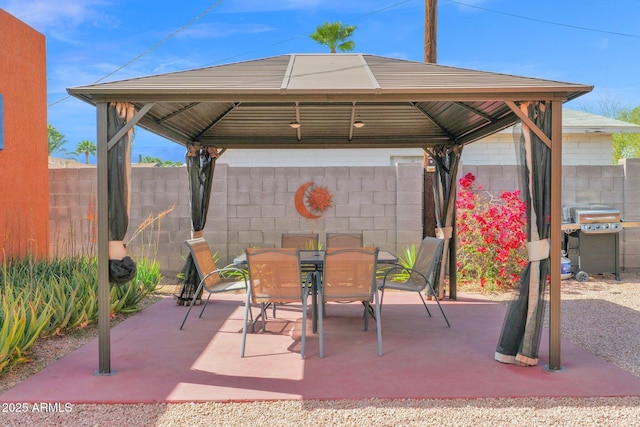 view of patio with a gazebo, outdoor dining area, a fenced backyard, and grilling area