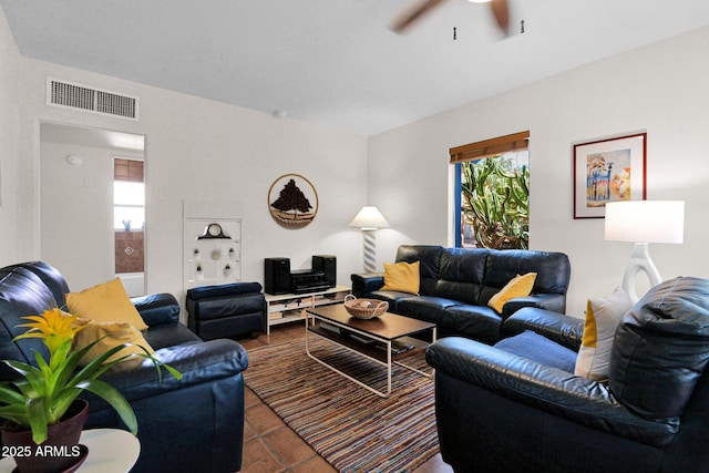 tiled living room featuring visible vents and a ceiling fan