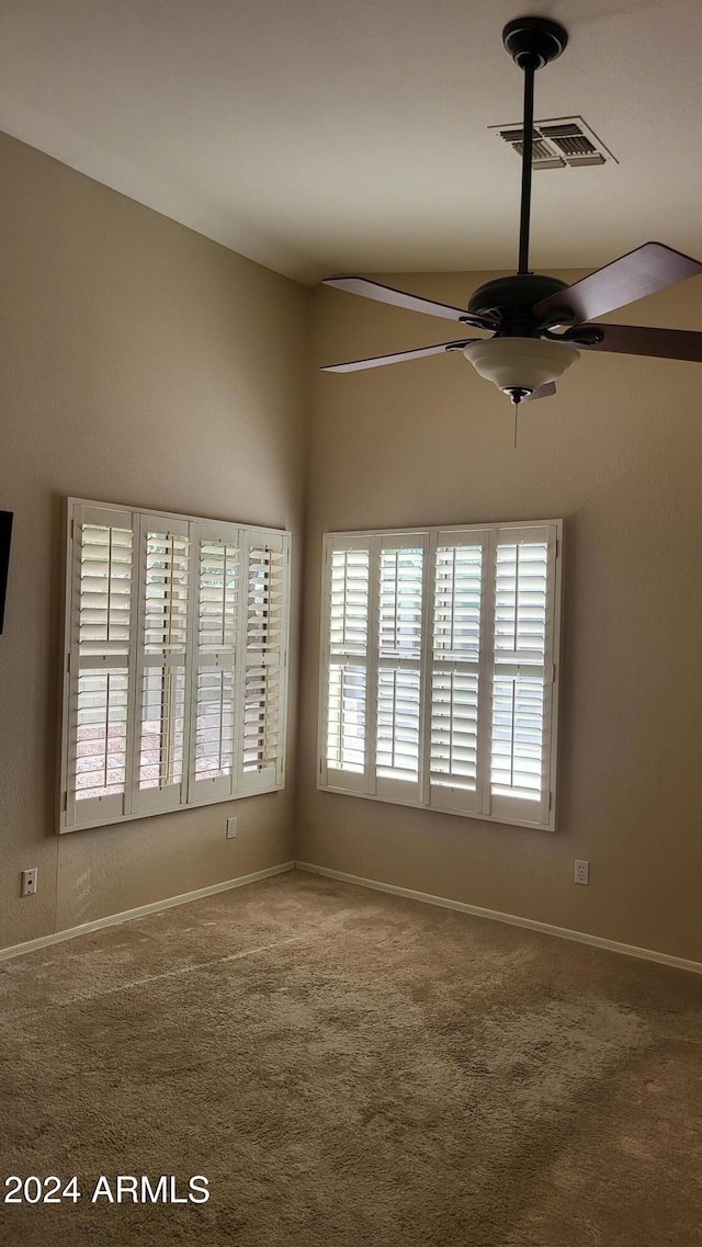 unfurnished room with ceiling fan and carpet flooring