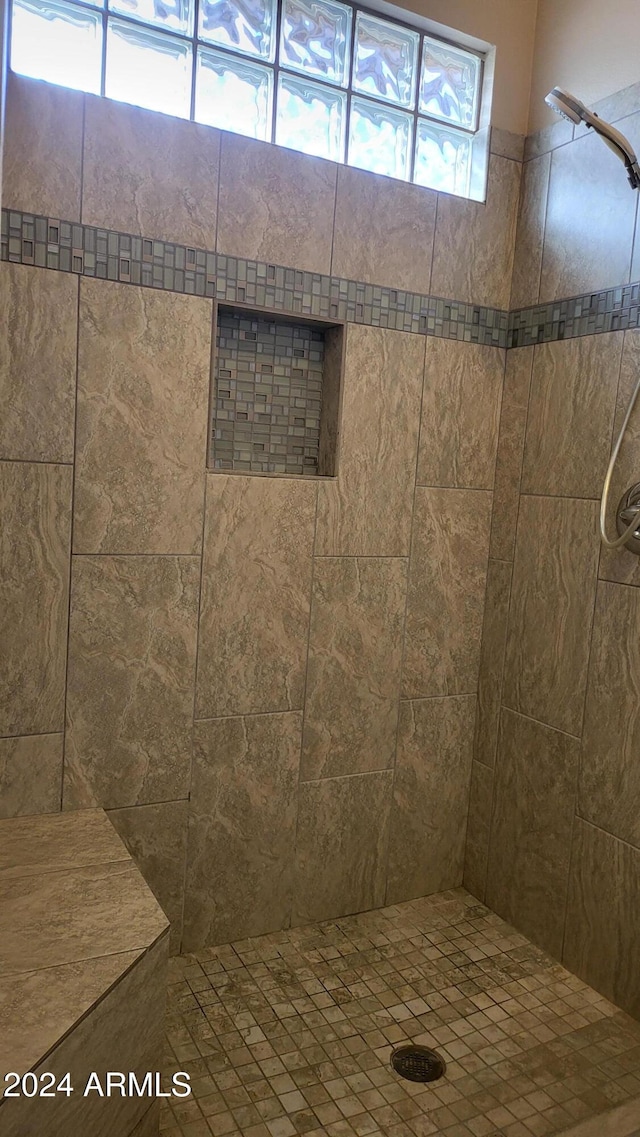 bathroom featuring tiled shower