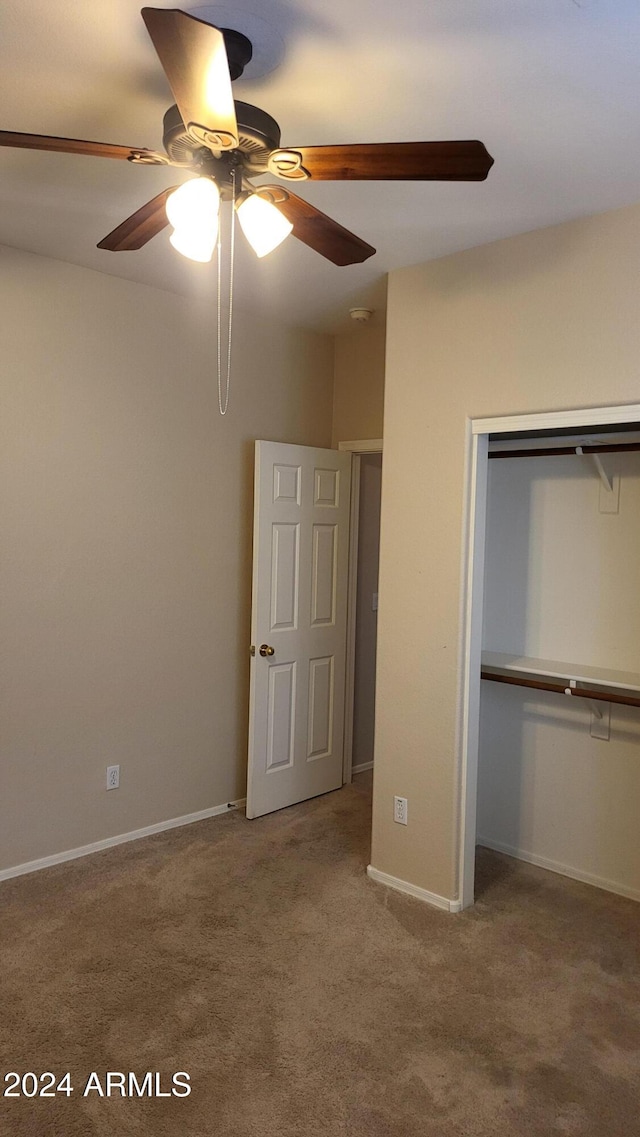 unfurnished bedroom with a closet, carpet flooring, and ceiling fan