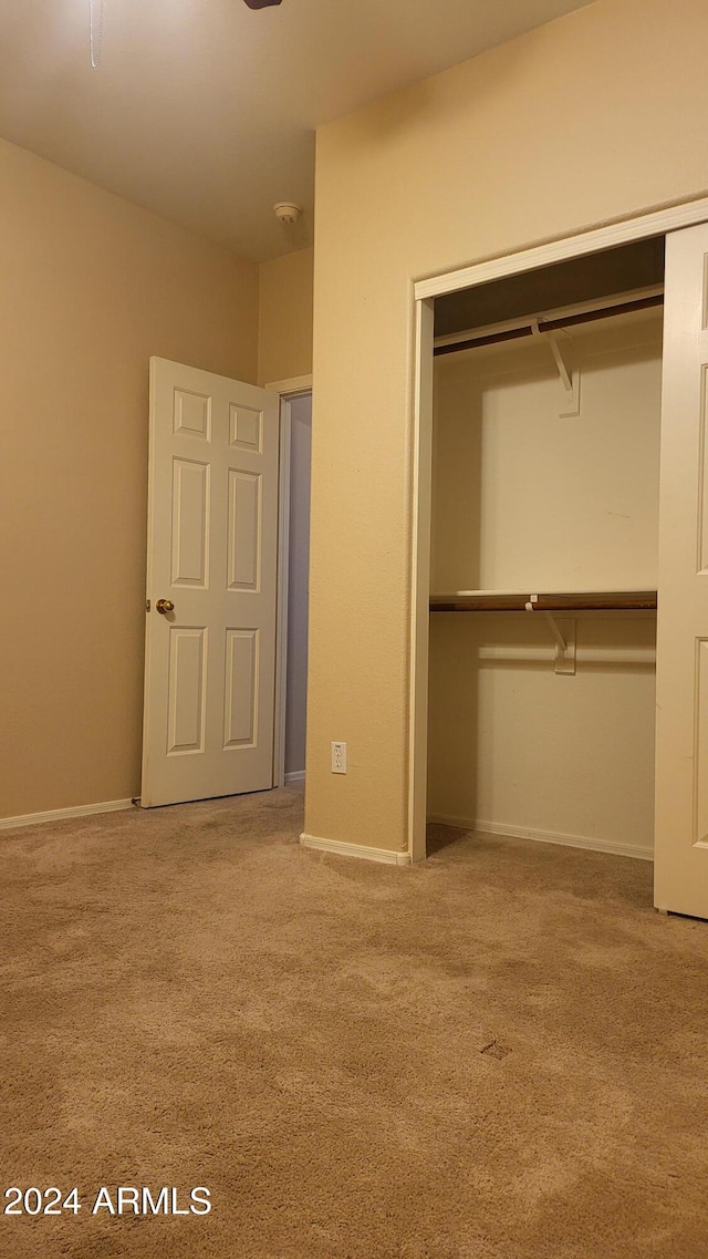 unfurnished bedroom with a closet and carpet