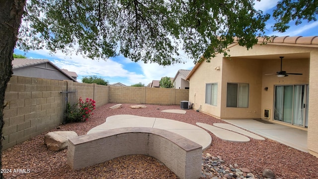 view of yard with a patio, central AC unit, and ceiling fan