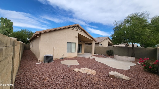 rear view of property featuring central air condition unit and a patio area