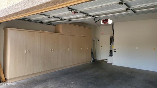 garage featuring gas water heater and a garage door opener