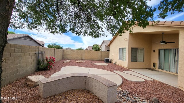3347 W Steinbeck Dr, Anthem, AZ 85086 - view of yard with central AC unit, ceiling fan, a patio area, and a fenced backyard