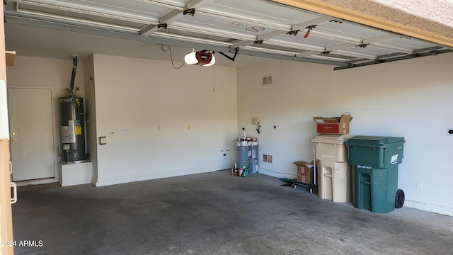 garage with a garage door opener and gas water heater