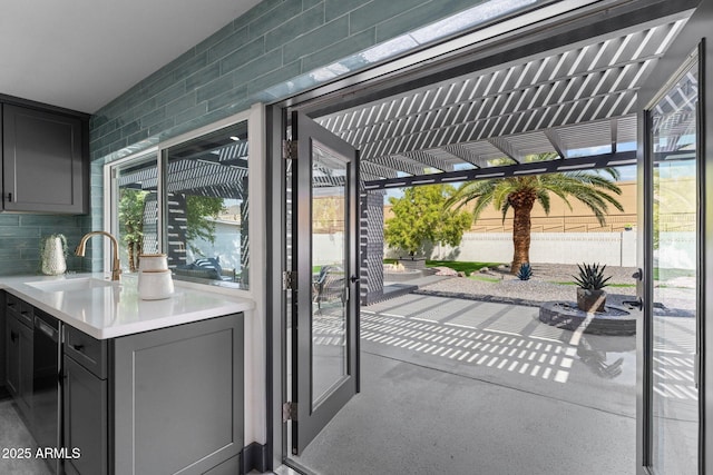 view of patio featuring wine cooler, a pergola, and a sink