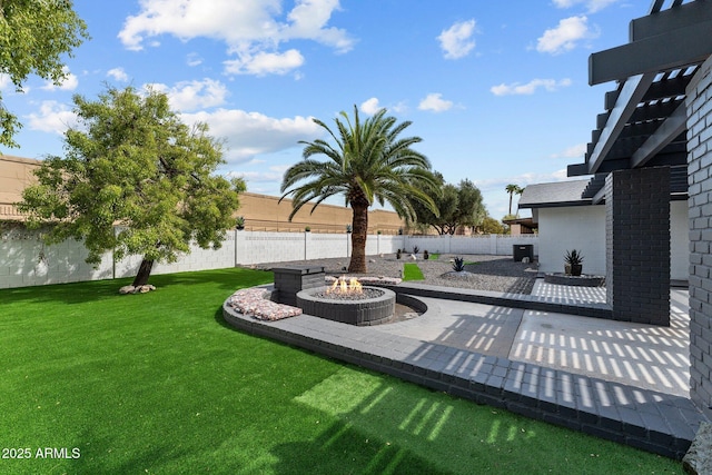 view of yard featuring a patio area, a fire pit, and a fenced backyard