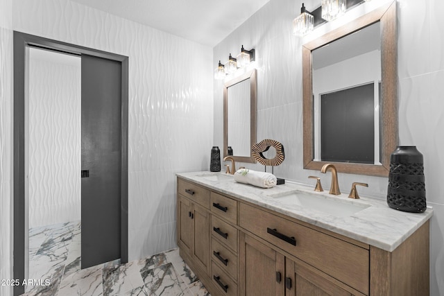 bathroom with a sink, marble finish floor, and double vanity