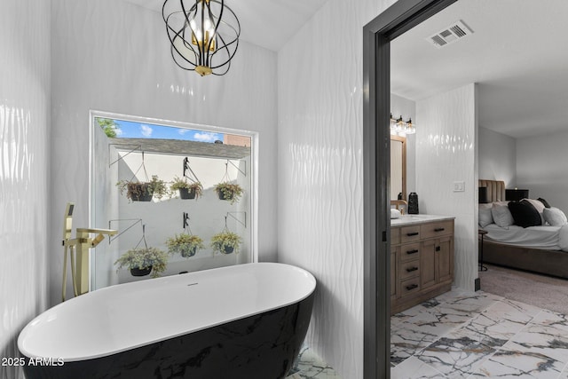 bathroom featuring vanity, visible vents, a freestanding tub, marble finish floor, and connected bathroom