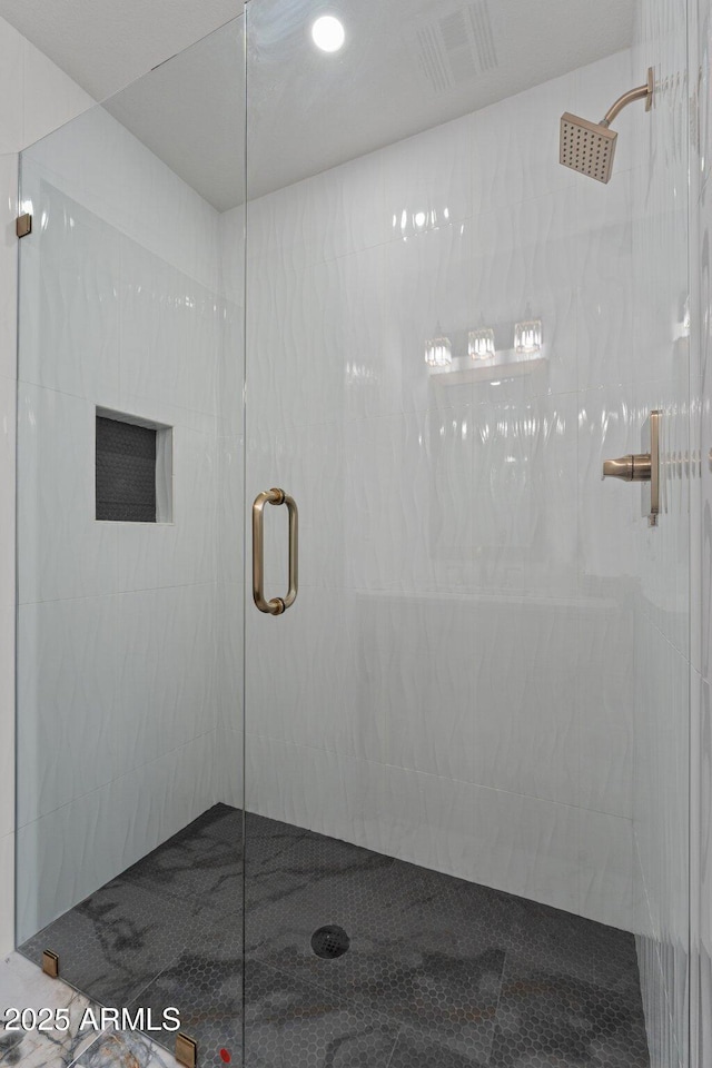 full bathroom featuring visible vents and a stall shower