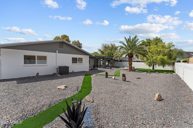 rear view of property with a patio, central AC unit, a pergola, and a fenced backyard