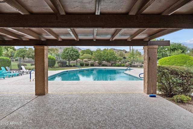 view of pool with a patio area, a fenced in pool, and fence