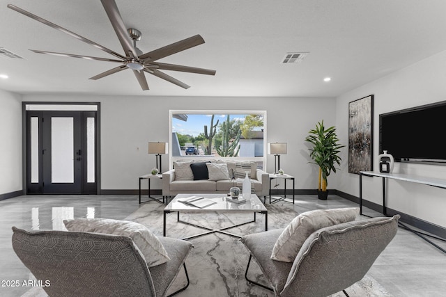 living area with recessed lighting, visible vents, and baseboards