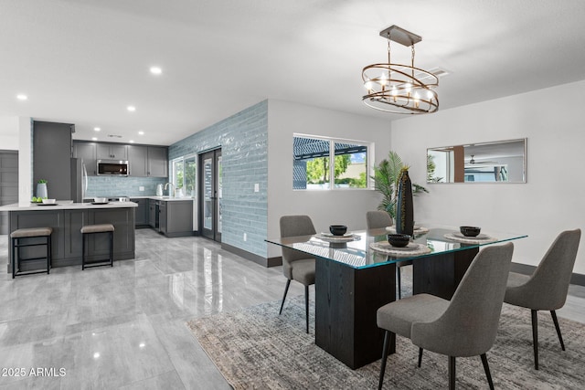 dining space featuring recessed lighting and a chandelier