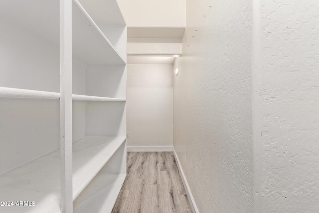 spacious closet featuring hardwood / wood-style floors