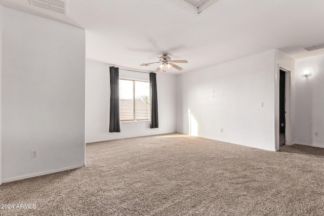 carpeted spare room with ceiling fan