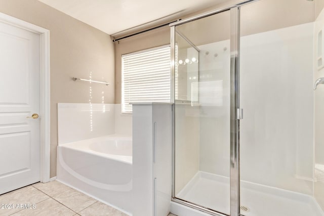 bathroom featuring tile patterned floors and independent shower and bath