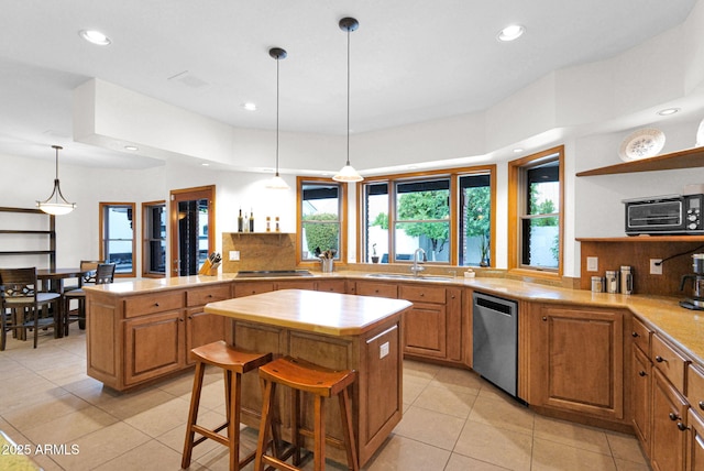 kitchen with open shelves, a sink, stainless steel dishwasher, a center island, and decorative backsplash