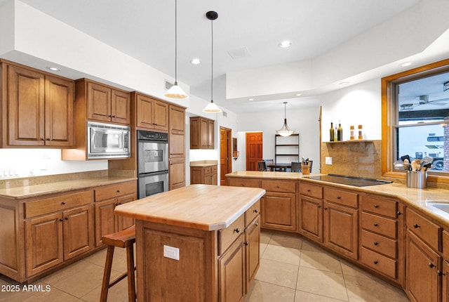 kitchen featuring a center island, brown cabinets, and stainless steel appliances