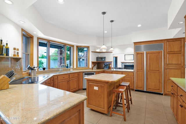 kitchen featuring a sink, open shelves, a peninsula, paneled refrigerator, and stainless steel dishwasher