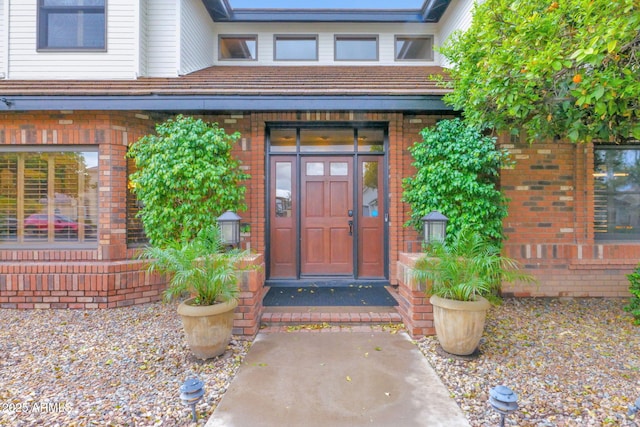 property entrance with brick siding