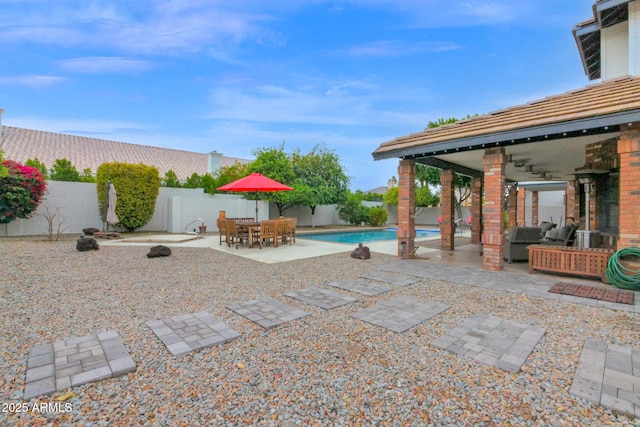 view of patio / terrace featuring outdoor dining space, a fenced backyard, and a fenced in pool