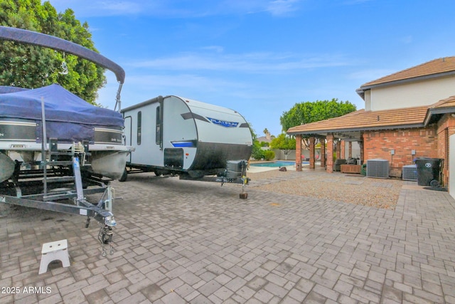 view of patio / terrace with cooling unit and an outdoor pool