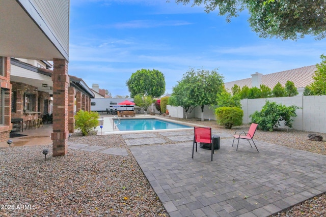 view of swimming pool with a patio area, a fenced in pool, and a fenced backyard