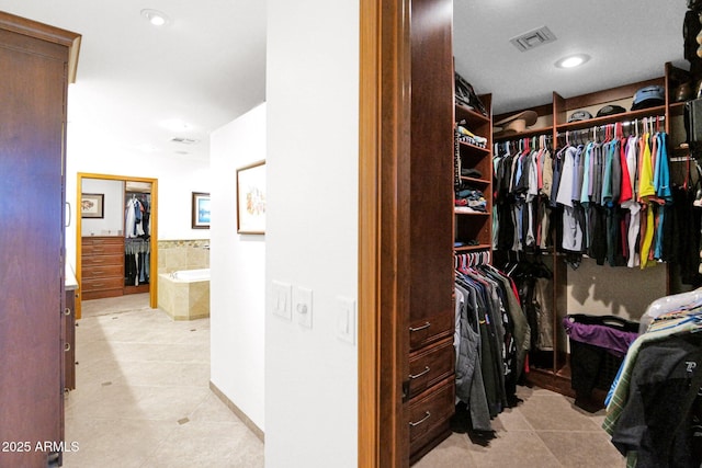 spacious closet featuring light tile patterned flooring and visible vents