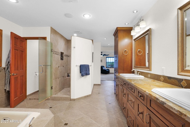 ensuite bathroom featuring ensuite bath, double vanity, a sink, tile patterned flooring, and a shower stall