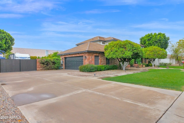 view of front of house with brick siding, an attached garage, fence, a front yard, and driveway