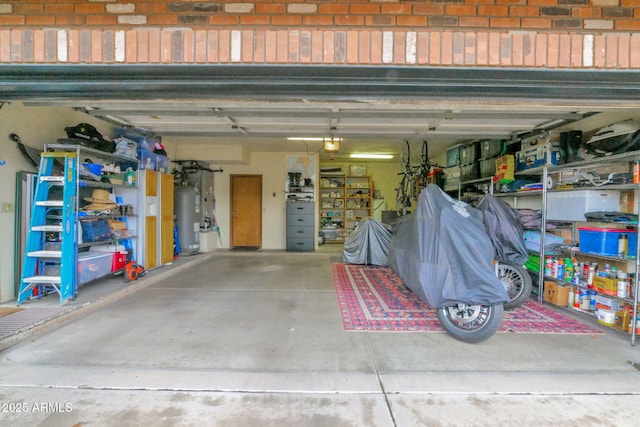 garage featuring a garage door opener and water heater