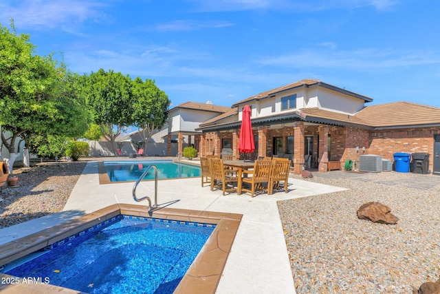 view of pool featuring a patio area, a fenced in pool, an in ground hot tub, and a fenced backyard