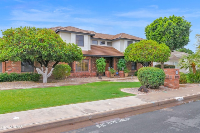 view of front of house featuring a front yard and a tile roof