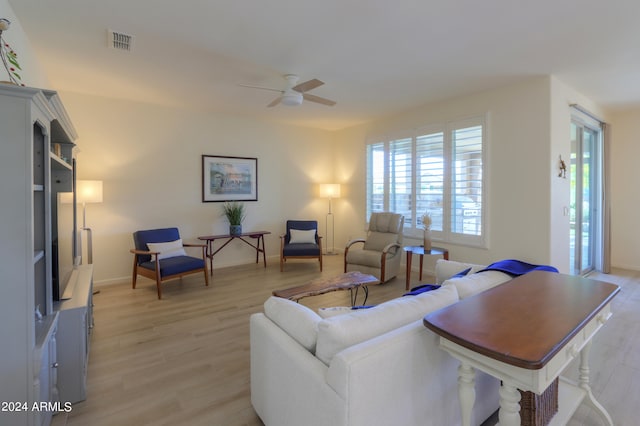 living room with light hardwood / wood-style flooring and ceiling fan