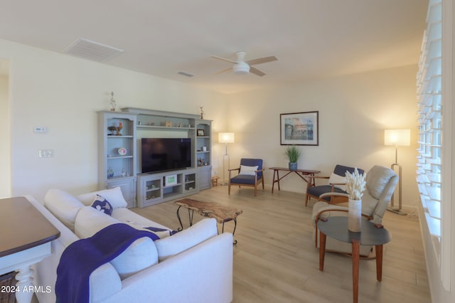 living room with ceiling fan and light wood-type flooring