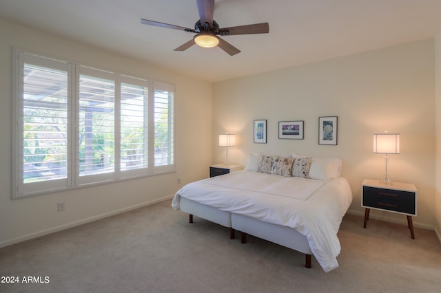 bedroom with multiple windows, ceiling fan, and carpet flooring