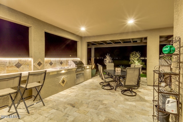 patio terrace at night with area for grilling and grilling area