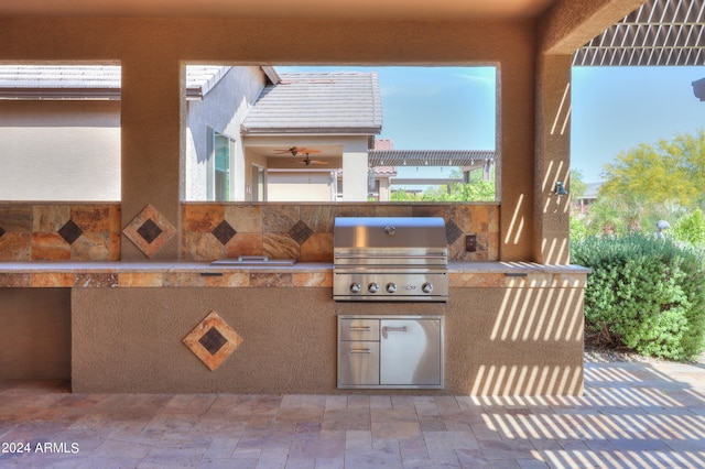 view of terrace featuring a grill, ceiling fan, and area for grilling