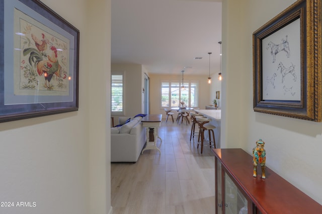 corridor with light hardwood / wood-style floors